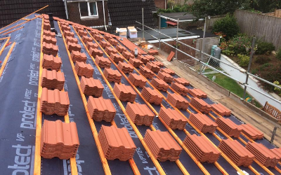 Birmingham Roofers tiling a roof